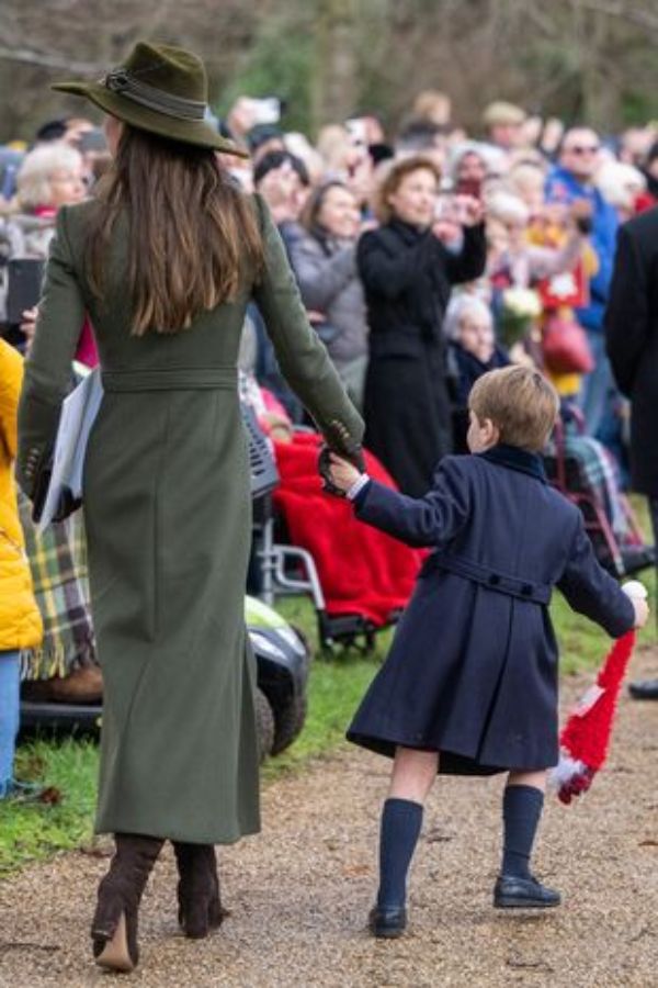 Prince Louis tugs at Kate Middleton's hand
