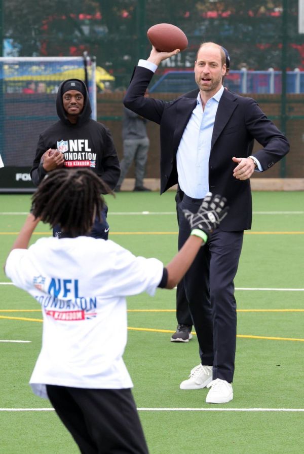 Prince William shows of his flag football skills during a visit to the NFL Foundation