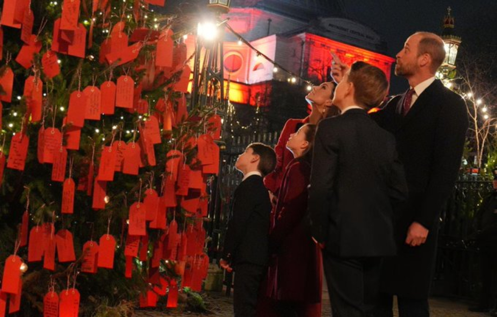 Prince Louis Holds Sweet Note To Granny And Grandpa At Carol Concert